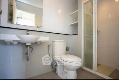 Modern bathroom with shower and sleek fixtures in a contemporary home.