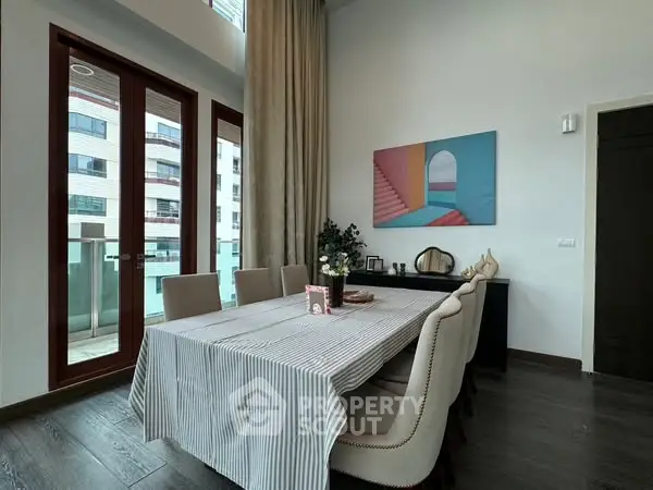 Elegant dining area with modern decor and large windows in a stylish apartment