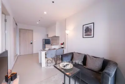 Modern living room with cozy sofa and dining area in open-plan apartment