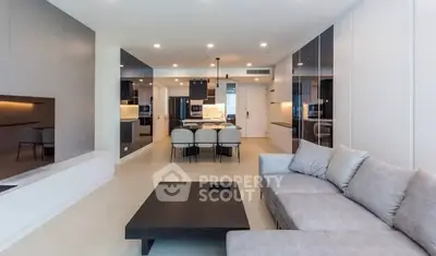 Modern open-plan living room with sleek kitchen and stylish furniture