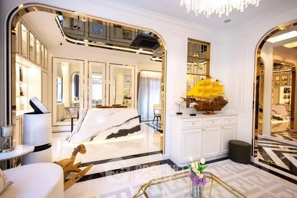 Luxurious living room with elegant decor and marble accents, featuring a stunning model ship centerpiece.