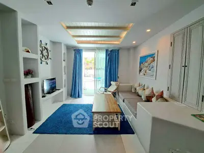 Charming living room with nautical decor, cozy seating, and bright natural light.
