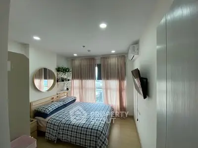 Cozy bedroom with large window and modern decor