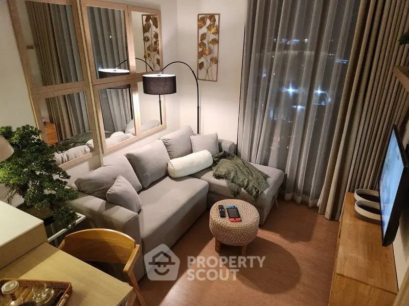 Cozy modern living room with stylish decor and city view, perfect for relaxation and entertainment.