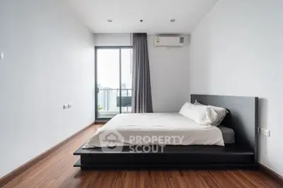 Modern minimalist bedroom with city view and sleek wooden flooring