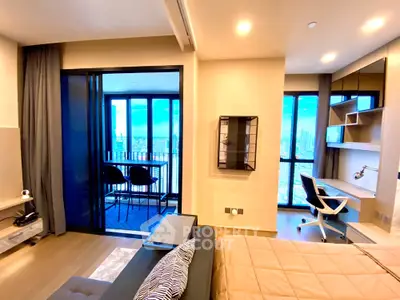 Modern apartment with balcony and city view, featuring stylish interior design and workspace.