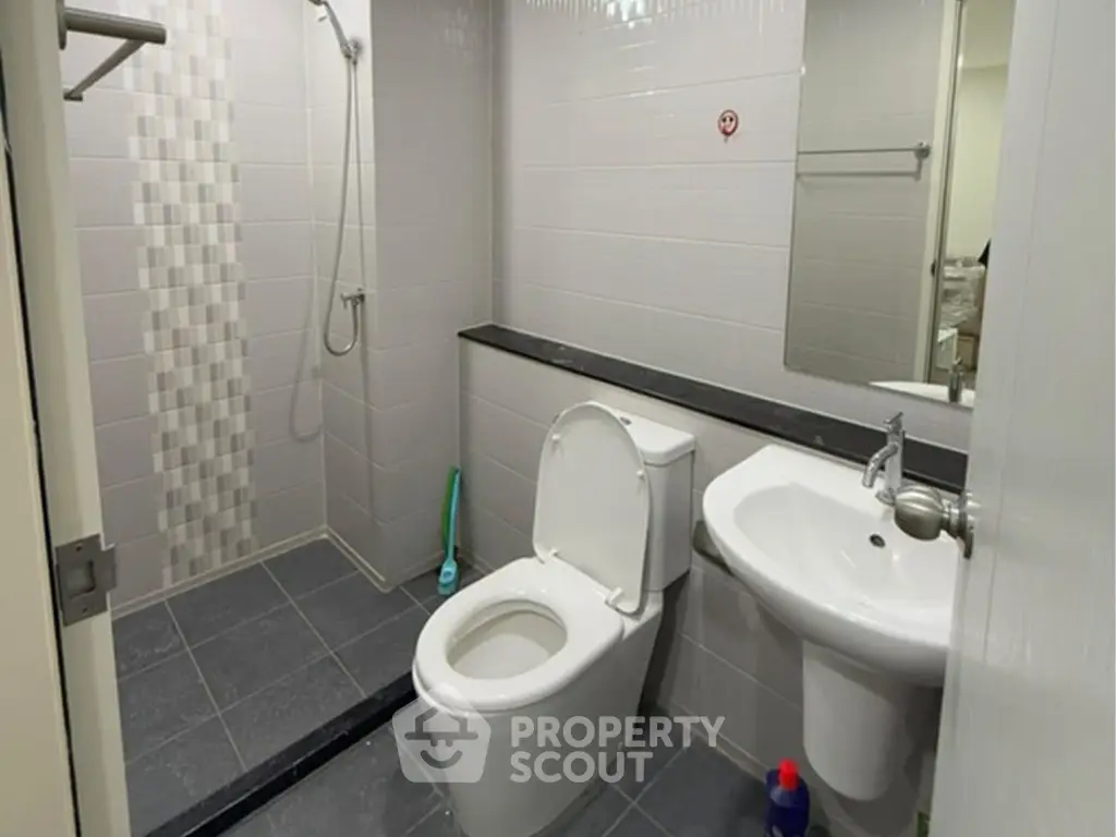 Modern bathroom with sleek fixtures and tiled shower area