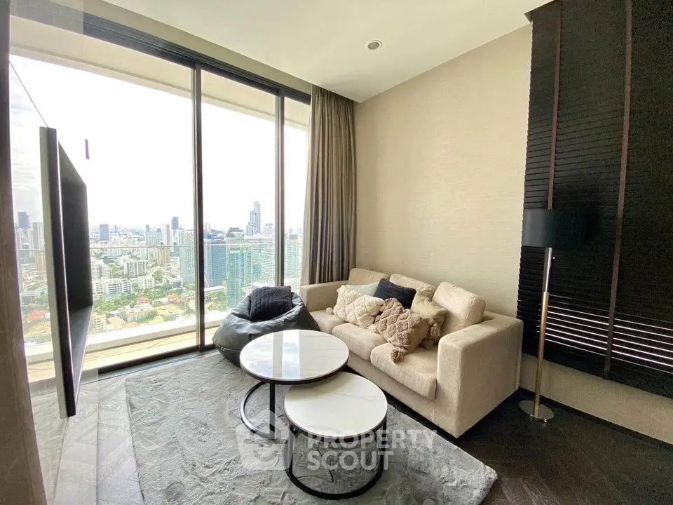 Modern living room with panoramic city view, cozy sofa, and stylish decor.