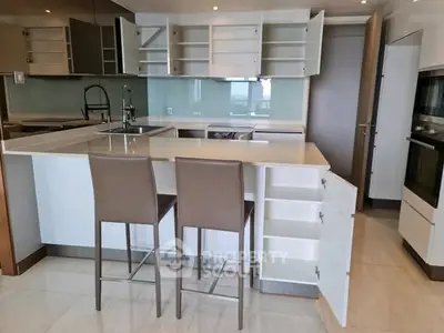 Modern kitchen with open cabinets and sleek bar stools