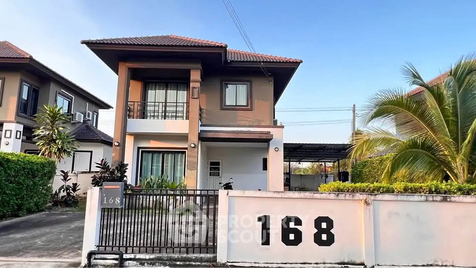 Charming two-story house with modern design, lush greenery, and spacious driveway in a serene neighborhood.
