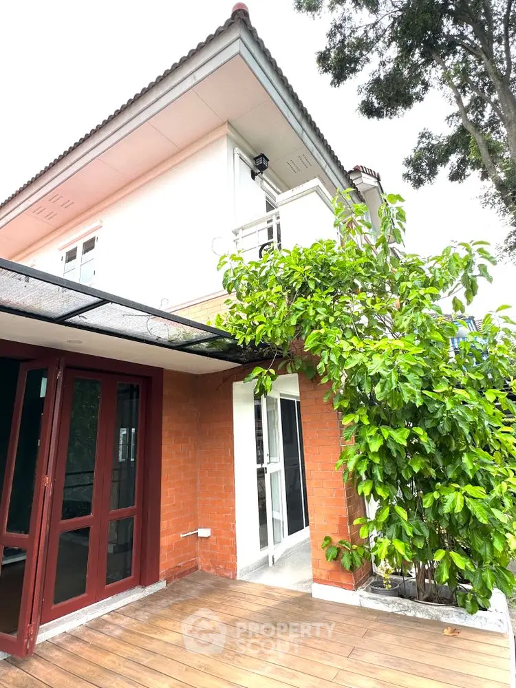 Charming two-story house with lush greenery and spacious balcony