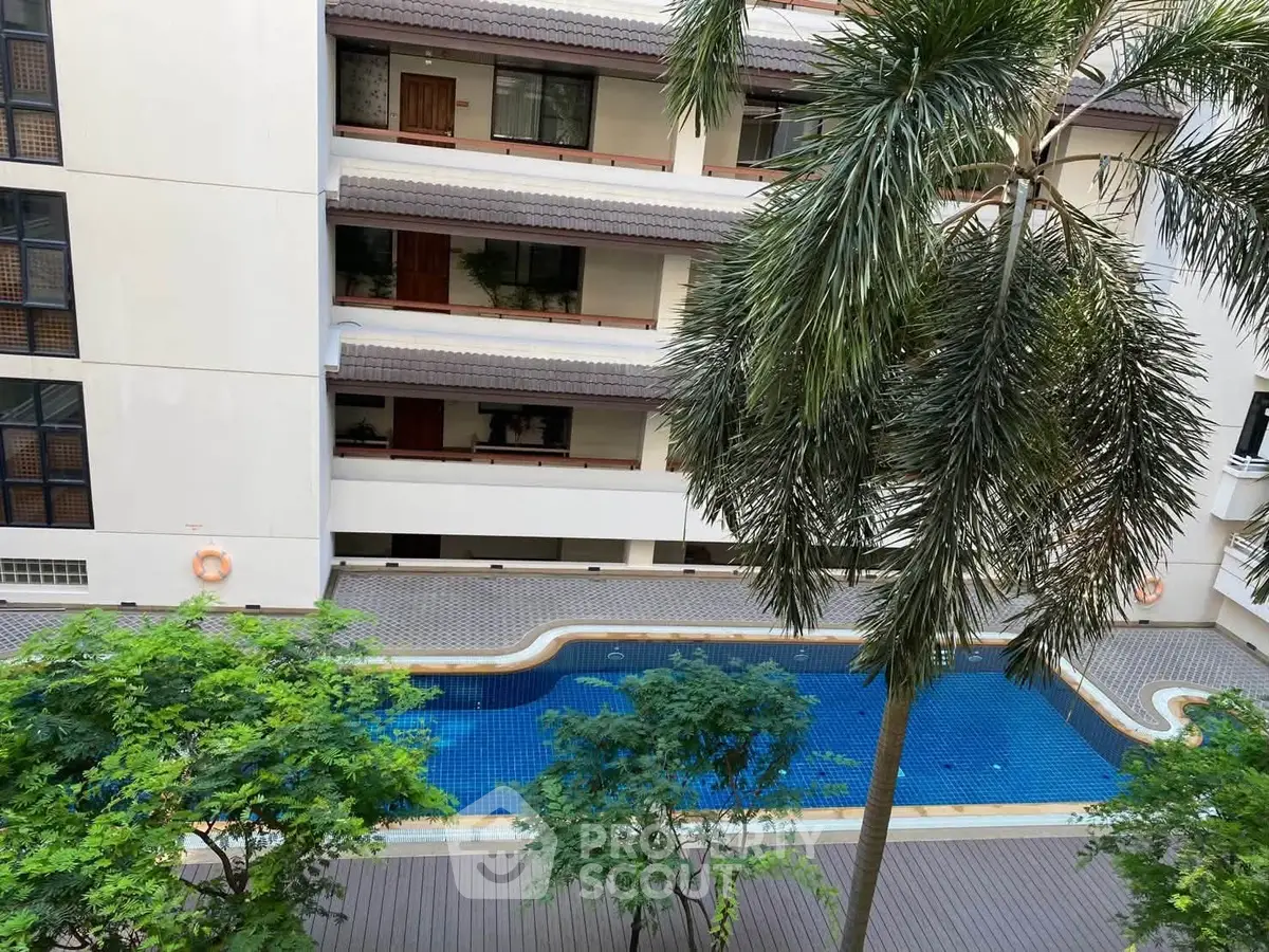 Stunning apartment complex with pool view and lush greenery, perfect for relaxation and modern living.