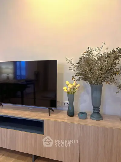 Modern living room with stylish TV stand and elegant floral decor