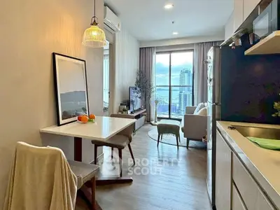 Modern open-plan living room with dining area and city view from window.