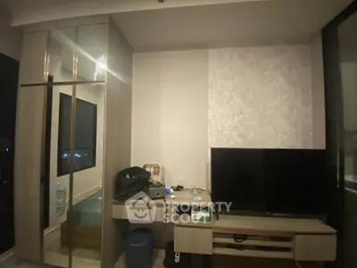 Modern living room with sleek TV unit and mirrored wardrobe