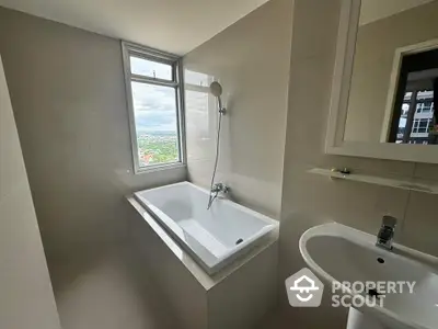 Modern bathroom with bathtub and scenic window view