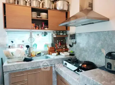 Modern kitchen with marble countertops and stainless steel appliances