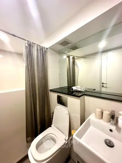 Modern bathroom with sleek design and large mirror