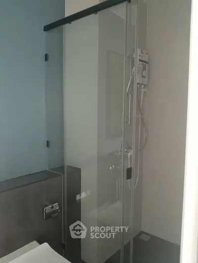 Modern bathroom with sleek glass shower enclosure and contemporary fixtures.