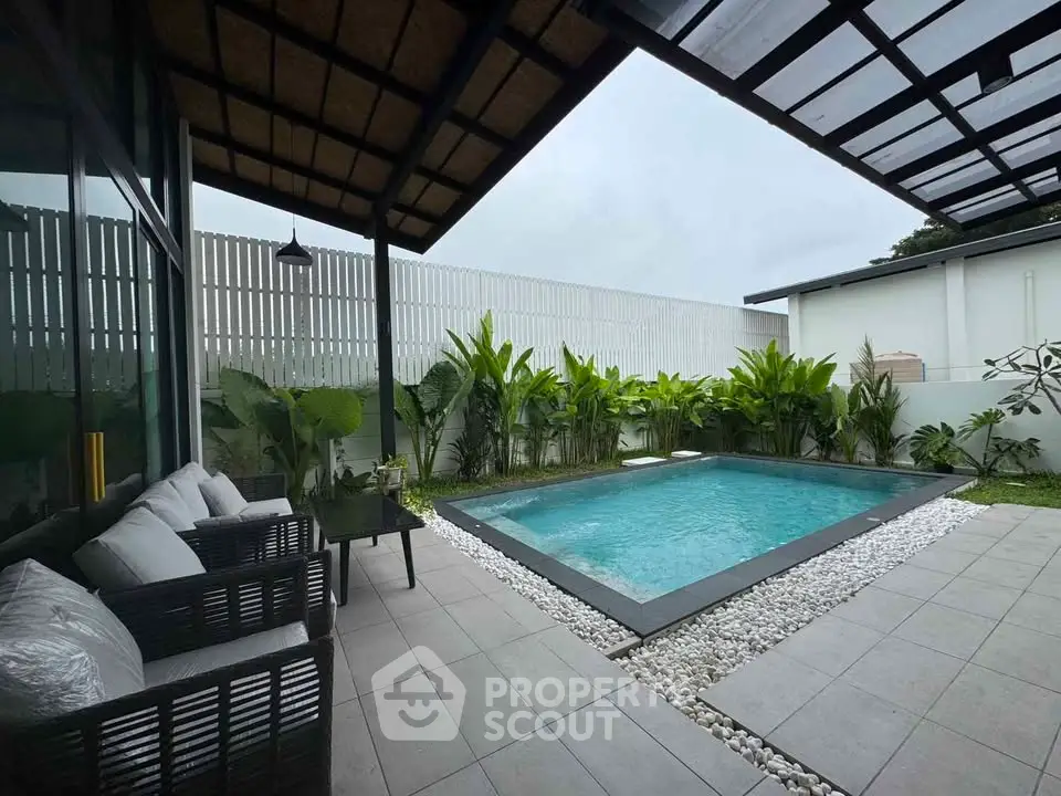 Modern backyard with pool and stylish patio seating area