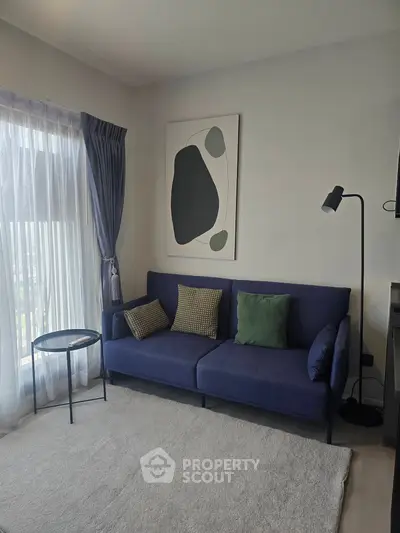 Cozy living room with modern blue sofa and stylish decor