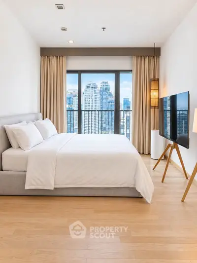 Spacious modern bedroom with city view and stylish decor