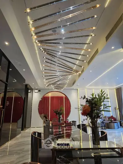 Luxurious modern living room with unique ceiling lights and elegant decor