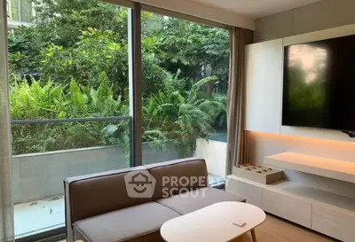 Modern living room with large window and lush garden view