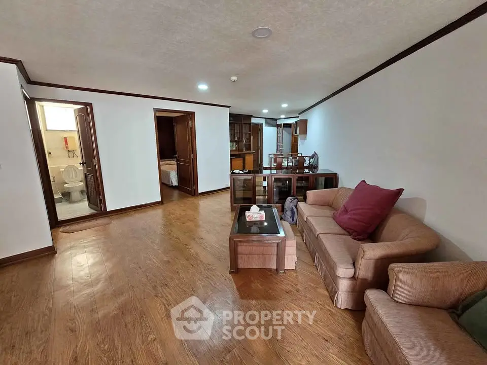 Spacious living room with wooden flooring and cozy furniture