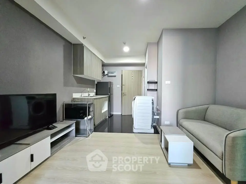 Modern living room with open kitchen layout and stylish furniture in a contemporary apartment.