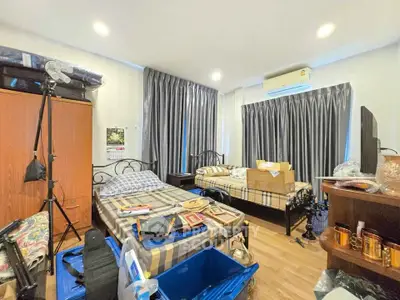 Spacious bedroom with twin beds, ample storage, and natural light, perfect for comfortable living.