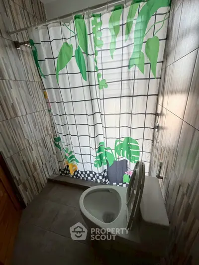 Cozy bathroom with modern tiled walls and vibrant shower curtain