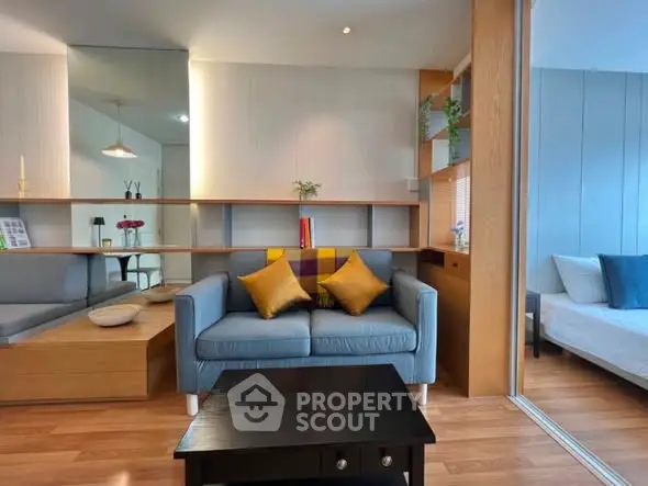 Modern living room with stylish decor and cozy seating area, featuring a sleek wooden floor and contemporary design.