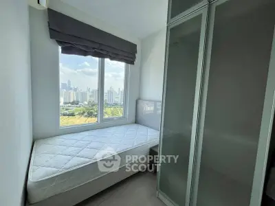Cozy bedroom with city view and ample natural light