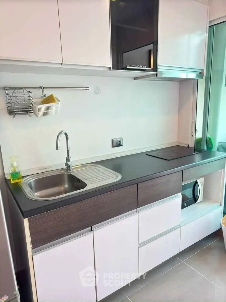 Modern kitchen with sleek cabinetry and built-in appliances in a contemporary apartment.