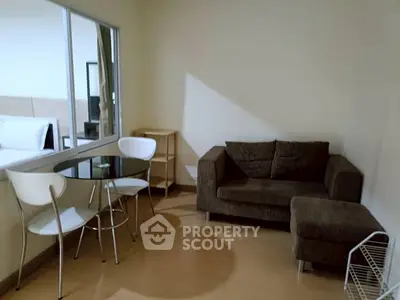 Cozy living room with modern furniture and dining area in a stylish apartment.