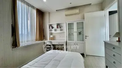 Cozy bedroom with study desk and ample natural light, perfect for a serene living experience.