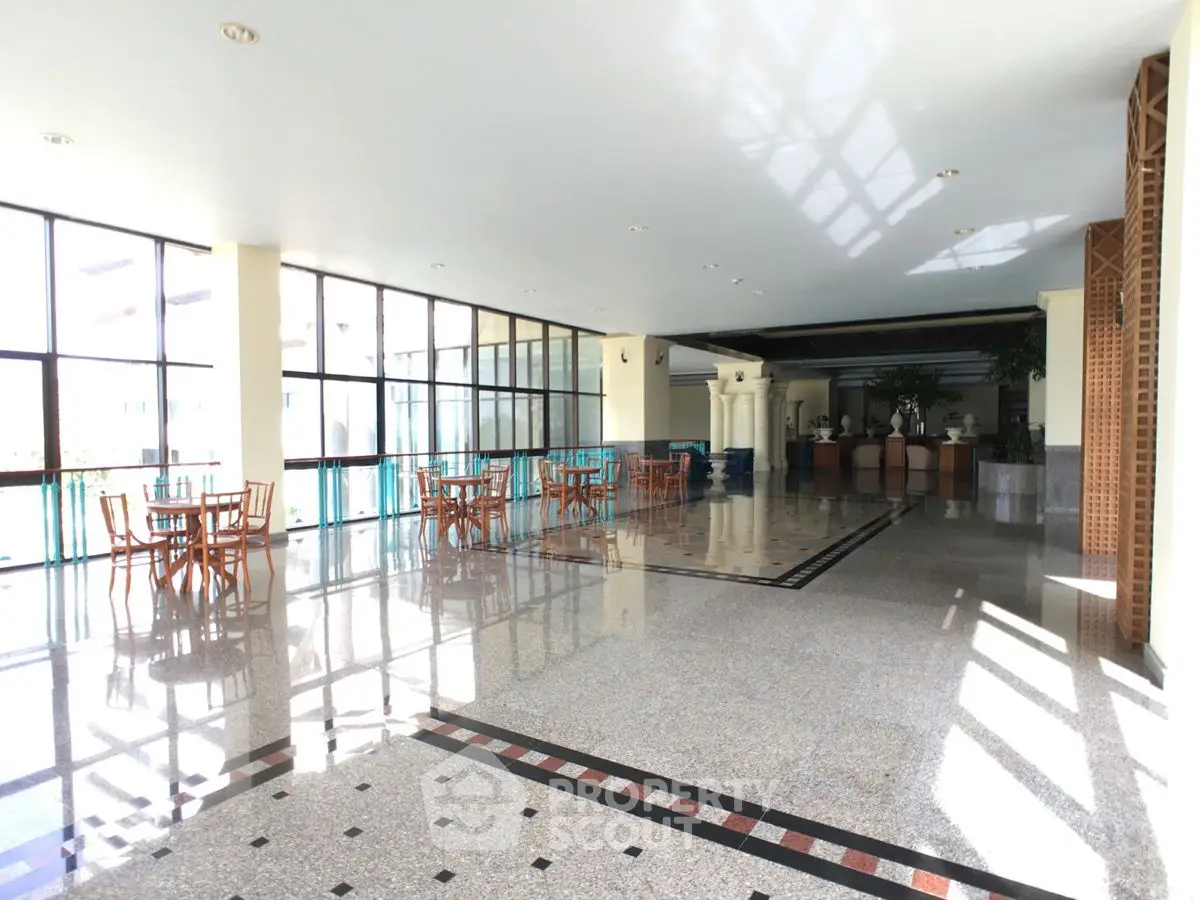Spacious and elegant communal area with large windows and polished flooring