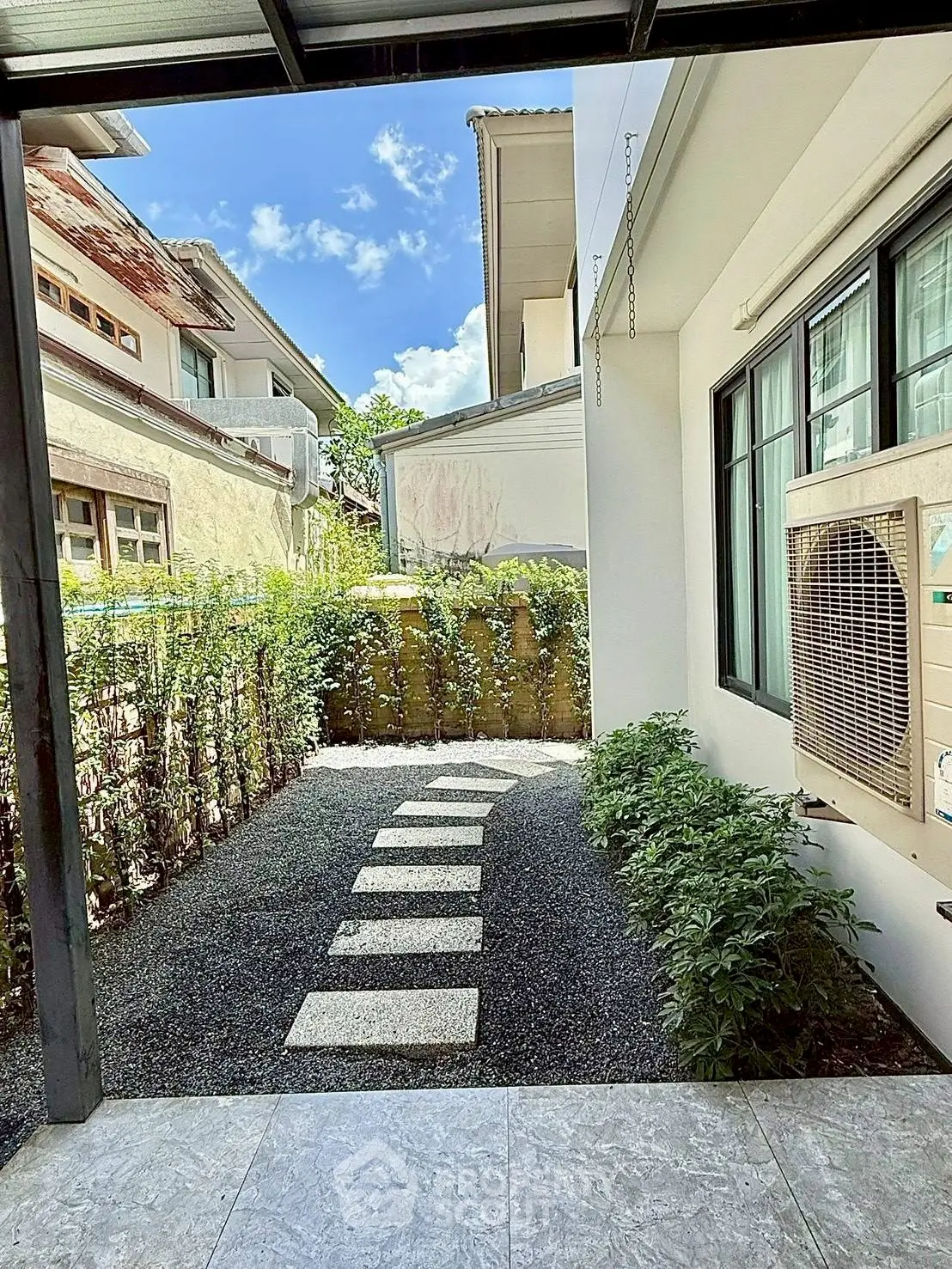 Charming garden view with stepping stones and lush greenery in a serene residential setting.