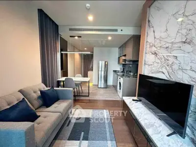 Modern living room with open kitchen, featuring stylish decor and appliances, perfect for urban living.