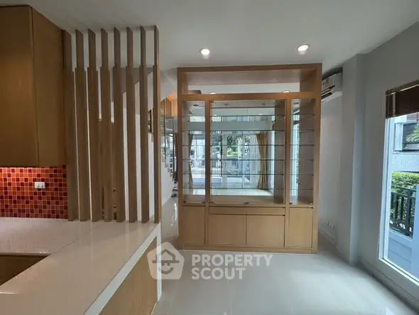 Modern open-plan living space with stylish wooden accents and ample natural light.