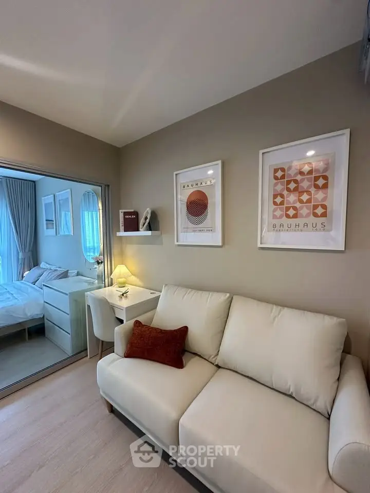 Modern living room with cozy sofa and stylish decor in a compact apartment.
