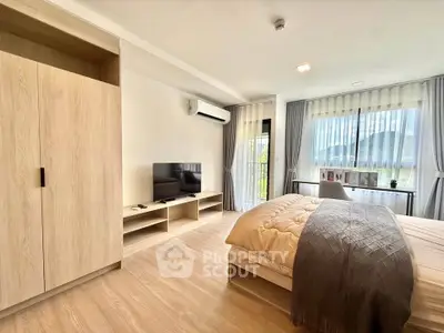 Spacious modern bedroom with natural light and stylish decor