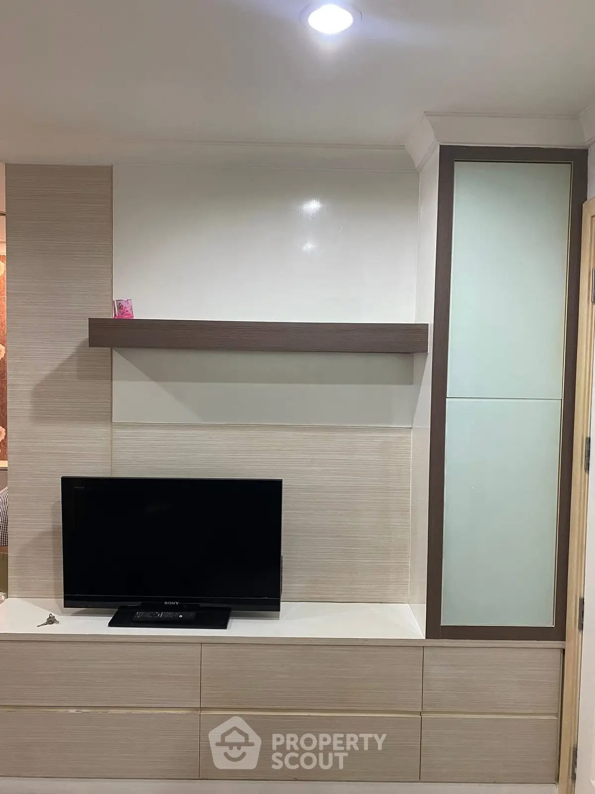 Modern living room with sleek TV unit and stylish shelving