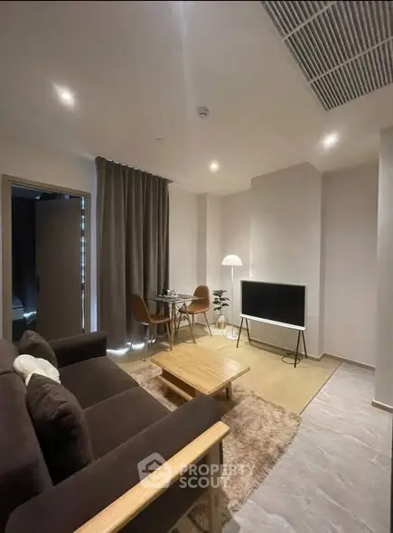 Modern living room with cozy seating and sleek TV setup