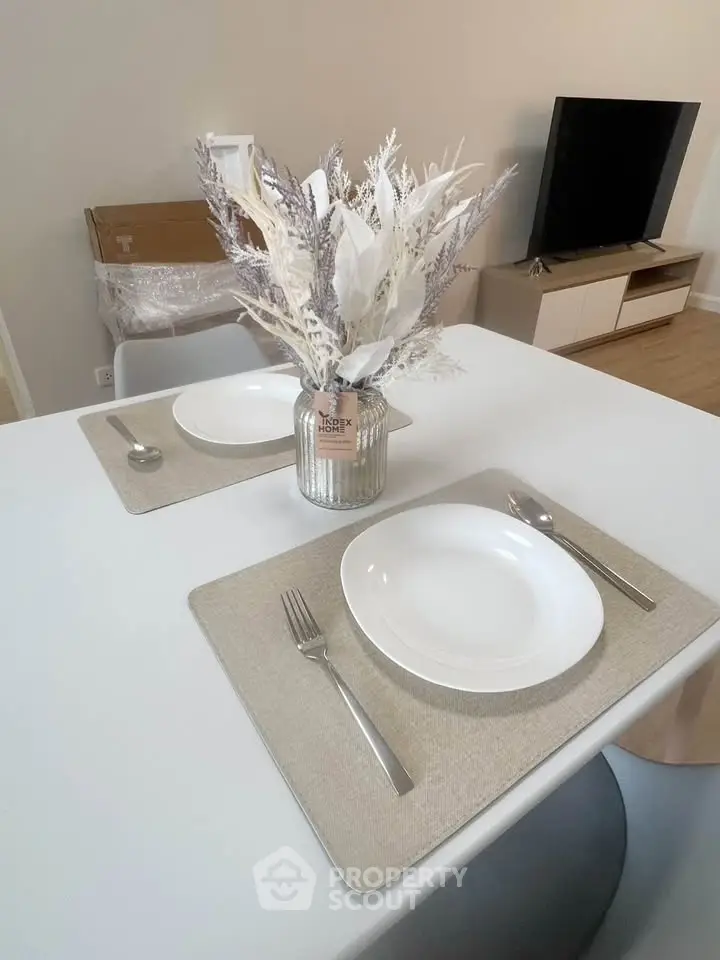 Modern dining setup with elegant tableware and decorative centerpiece in a stylish living space.