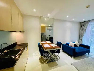 Modern open-layout kitchen and living area with sleek design and cozy seating.