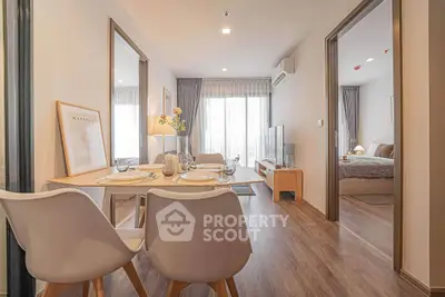 Modern open-plan living and dining area with stylish decor and natural light.