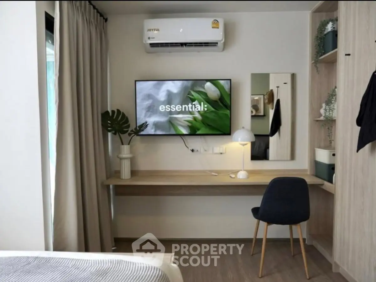 Modern study nook with wall-mounted TV and air conditioning in stylish apartment.