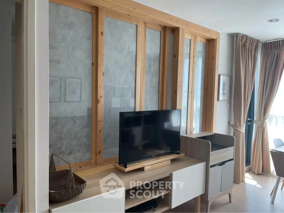 Modern living room with stylish wooden TV stand and natural light